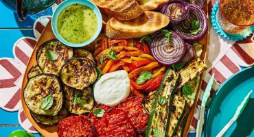 vegan mediterranean meal with vegetables and legumes on table