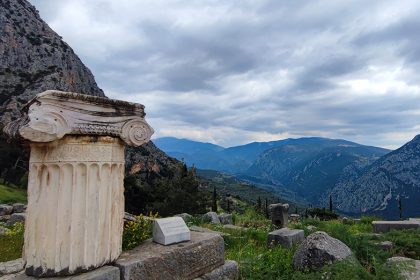 Ancient column in Delphi with mountain view towards Arachova, Greece