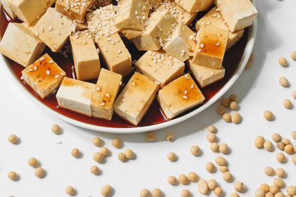 Block of tofu on a wooden board, introducing one of the world's most versatile plant-based foods